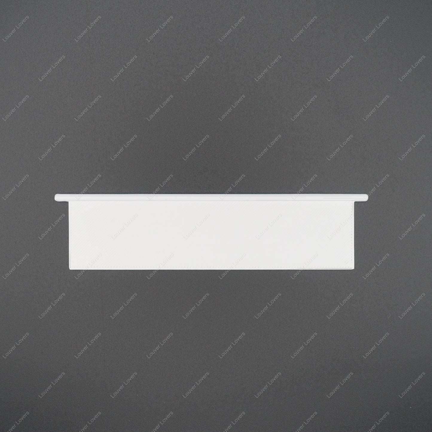 This is a photo of a 4 1/16" wide 1 1/16" tall natural colored vent slat with a black background.