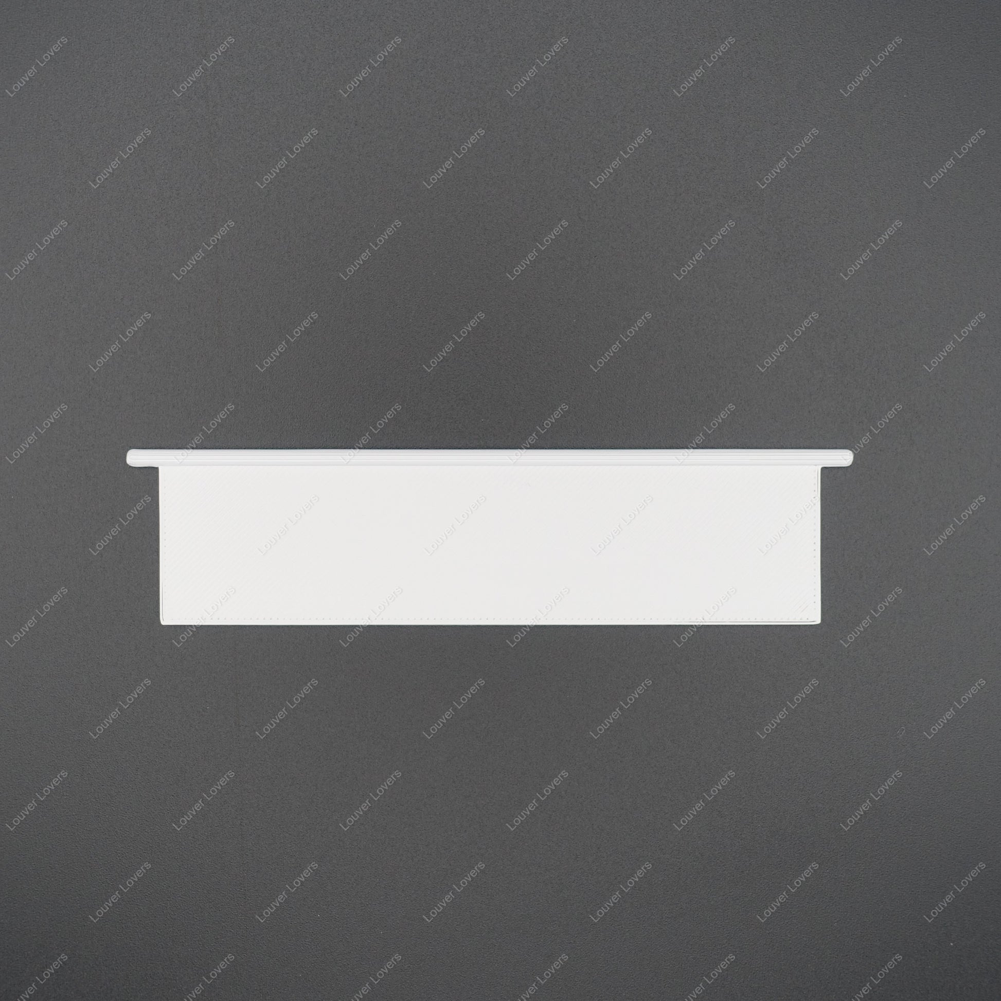 This is a photo of a 4 1/16" wide 1 1/16" tall natural colored vent slat with a black background.